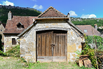 Old door of an old barn in a Périgord village. France.
