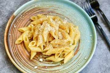 Home made fresh  italian  penne pasta    cacio e pepe. Pasta with Parmesan cheese and black peper