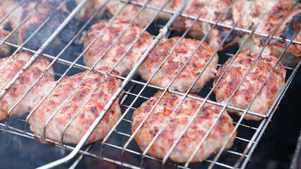 Meat cutlets are grilled on wire rack closeup