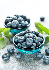 Freshly picked blueberries on a concrete background. Concept for healthy eating