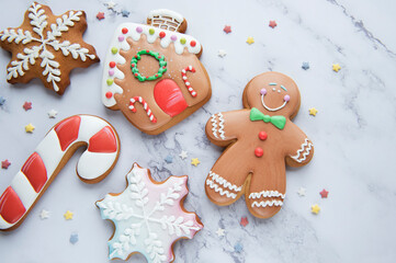Christmas gingerbread cookies on white marble background