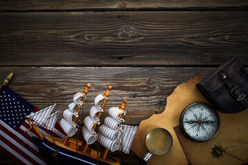 Columbus Day. Vintage discovery equipment with copy space on dark wooden background.