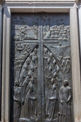 Detail of the door with Bas-relief carvings depicting the symbols of Jesus and the Catholic clergy at Viterbo Cathedral, is the main place of worship in the city of Viterbo.