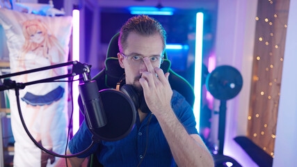 Fototapeta premium Confident male gamer put on glasses with middle finger and get ready to play