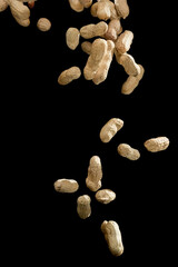 Realistic freeze motion of flying peanuts on black background