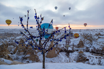 Blue evil eye / nazar boncugu, Turkish symbols hanging on a tree; Cappadocia