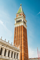 Fototapeta na wymiar St Mark's Campanile, the bell tower of St Mark's Basilica in Venice, Italy. Blue sky on the background.