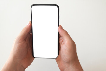 Smartphone with white screen in woman's hand.
phone with white screen for typing.technology concept.mackup concept.