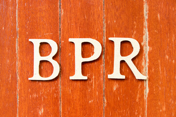 Alphabet letter in word BPR (Abbreviation of Business Process Reengineering or Batch processing record) on old red color wood plate background