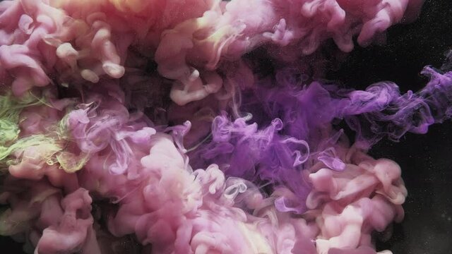 Paint water shot. Color vapor cloud. Logo opener. Underwater ink splash animation. Purple yellow dye mix motion on black glitter dust particles abstract background for transition.