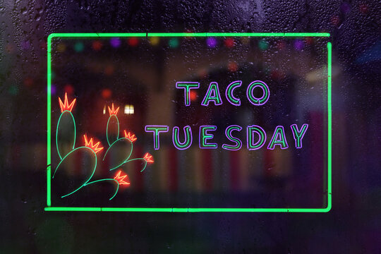 Vintage Taco Tuesday Neon Sign in Rainy Window of Mexican Restaurant