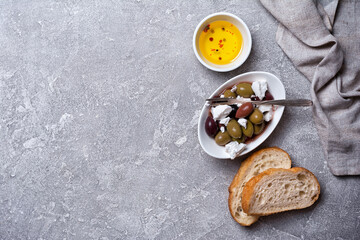 Fototapeta na wymiar Bowl of delicious olives with Feta cheese and bread