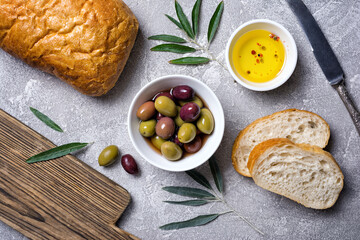 Fototapeta na wymiar Bowl of delicious olives with oil and bread