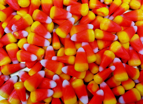 Candy corn background close-up top view stock images. Popular halloween candy frame images. Pile of candy corn photo