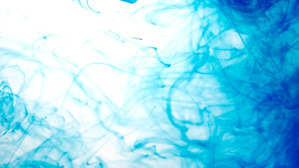 Colored acrylic paints in water. Blue watercolor ink in water on a white background. Blue cloud of ink on a white background. Abstract background.