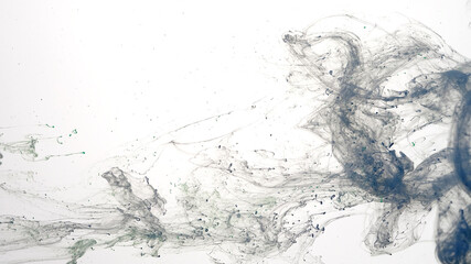 Blue watercolor ink in water on a white background. Blue cloud of ink on a white background. Abstract background. Drops of blue ink in water.
