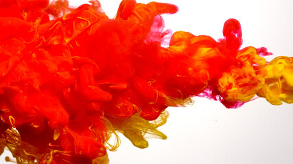 Red-yellow cloud of ink on a white background. Beautiful abstract background. Drops of red-yellow...