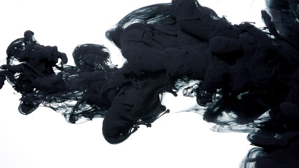 Drops of black ink in water. Colored acrylic paints in water. Black watercolor ink in water on a white background. Black cloud of ink on a white background.