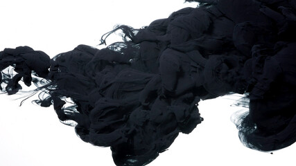 Black watercolor ink in water on a white background. Black cloud of ink on a white background....