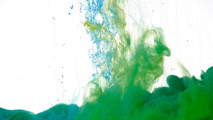 Blue and green watercolor ink in water on a white background. Colored cloud of ink on a white background. Beautiful abstract background.