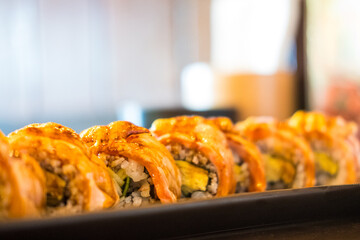 Burned salmon sushi roll. Selective focus