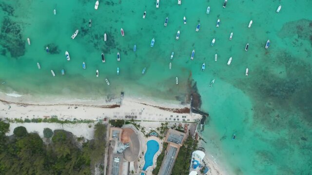 Top down aerial view with moored boats at the coastline of Caribbean Sea at Playa del Carmen, Mexico