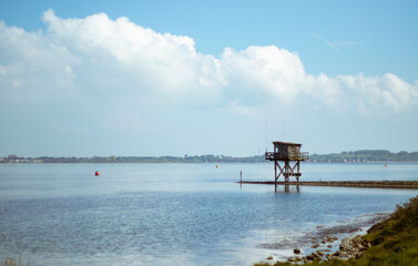 Fototapeta na wymiar water tower on pier over lake