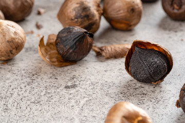 Fermented black garlic. The color is a result of the Maillard reaction or caramelization. Black garlic can help to regulate blood sugar levels. negative space. selective focus.