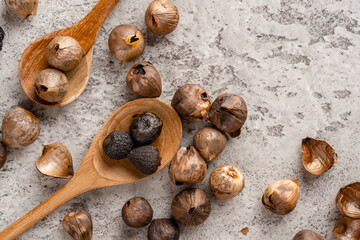 Fermented black garlic. The color is a result of the Maillard reaction or caramelization. Black garlic can help to regulate blood sugar levels. negative space. selective focus.