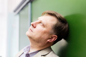 Fototapeta premium The thoughtful professor stands at the blackboard with his head dreamily thrown up.