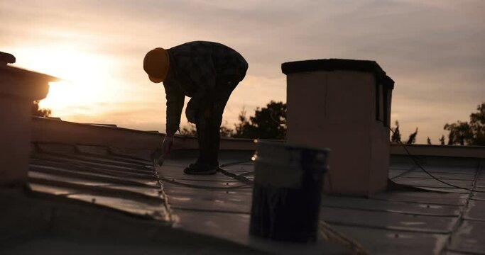 builder roofer painter worker painting the roof, 4k