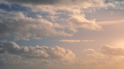 Obraz premium Wonderful view of cumulus clouds sky with orange sun light at sunset of summer