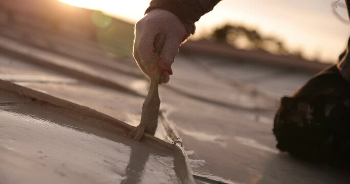 builder roofer painter worker painting the roof, 4k