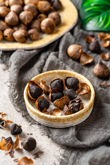 Fermented black garlic. The color is a result of the Maillard reaction or caramelization. Black garlic can help to regulate blood sugar levels. negative space. selective focus.