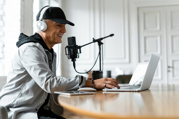A blogger on the radio communicates with listeners. Radio host good news. The speaker speaks into the microphone. Live broadcast recording of the podcast show. Journalist and interview.