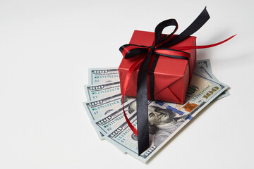 Gift box with dollar banknotes on white background