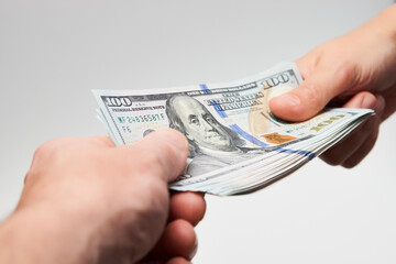 Hand giving dollar money, close-up. Hands holding a dollar