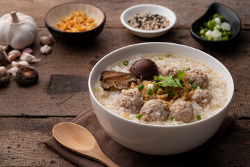 Boiled Rice porridge with minced pork.Thai rice soup(Khao Tom moo sap).popular breakfast in Thailand