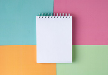 White notebook on a multicolored background
