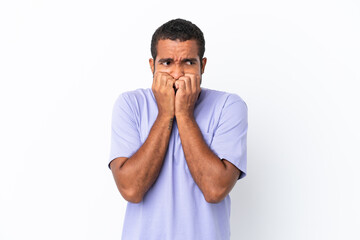 Young Ecuadorian man isolated on white background nervous and scared putting hands to mouth