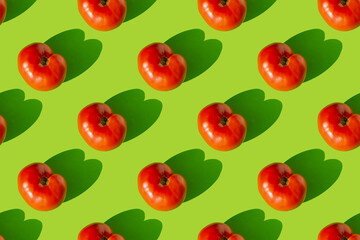 Pattern of red tomatoes with shadow on a green background. Seamless pattern