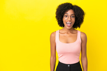 Fototapeta na wymiar Young African American woman isolated on yellow background with surprise facial expression