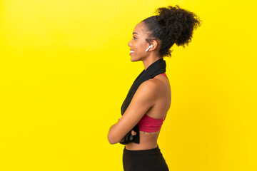 Young African sport woman isolated on yellow background in lateral position