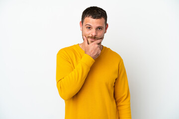 Young Brazilian man isolated on white background thinking