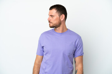 Young Brazilian man isolated on white background looking to the side