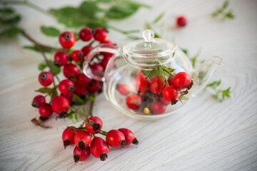 ripe red rose hips on a wooden table