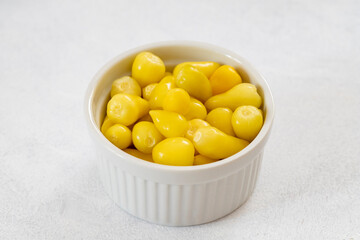 yellow hot pepper pickle on a white background