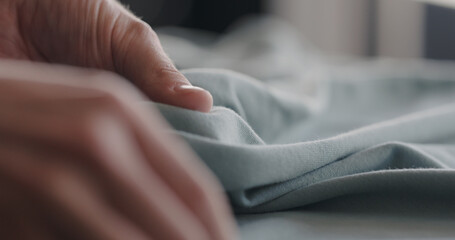 man touching cyan cotton clothes closeup