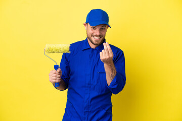 Painter Brazilian man isolated on yellow background making money gesture