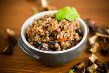 boiled buckwheat with vegetables and dried forest mushrooms in a ceramic mold